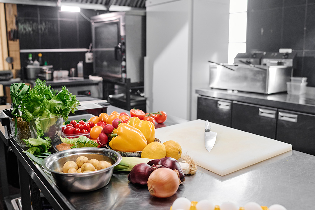 industrial kitchen with vegetables ready to be chopped